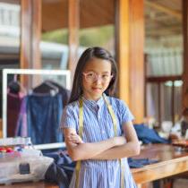 photo of young teen in charge of dress making workshop